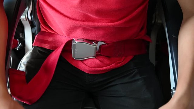 4K Close up hand of asian man fasten seatbelt on the airplane.