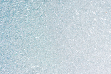 Fototapeta premium Frozen winter abstract background on the window glass with copy space