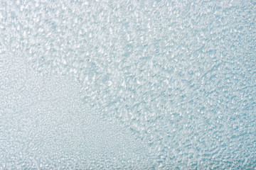 Frozen winter abstract background on the window glass with copy space