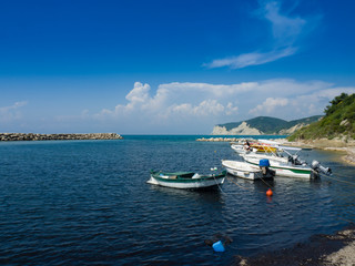 Fototapeta na wymiar Pleasure boats moored off Kassiopi beach on the Greek island of Corfu Greece.