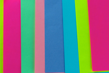 Blue,pink,yellow,purple,green neon paper color for background. Striped geometric pattern of bright colors.