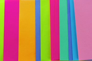 Blue,pink,yellow,purple,green,orange neon paper color for background. Striped geometric pattern of bright colors.