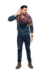 Naklejka premium Full-length shot of Hippie man listening to something by putting hand on the ear on isolated white background