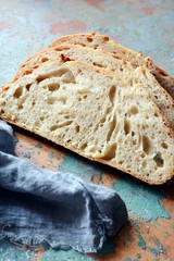 Fresh homemade bread on a gray-blue background, on whole wheat flour. French bread round shape. Bread baking. Unleavened bread