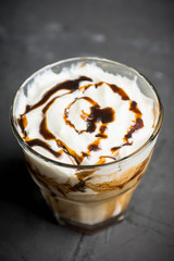 Sweet creamy latte on rustic background. Selective focus. Shallow depth of field.
