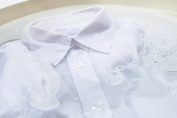 Obraz na płótnie Canvas Soak cloth before washing, white shirt