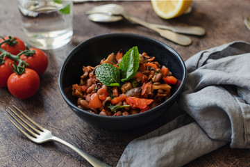 Vegetable Stew with Beans, Mushrooms and Tomatoes on a wooden background