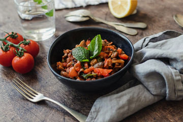Vegetable Stew with Beans, Mushrooms and Tomatoes on a wooden background