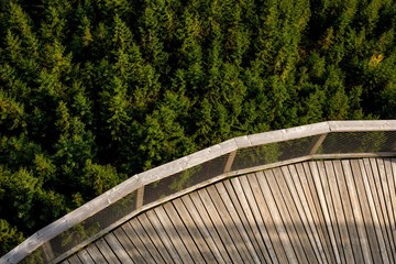 Forest and road viewing platform of boards. View of the forest from the height of the attraction in the Czech village Dolni Morava. A great view from a height. Interesting places for tourism.