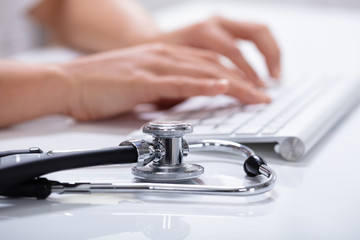 Doctor's Hand Typing On Computer Keyboard
