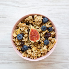 Fruit granola on a white wooden table, top view. Flat lay, from above, overhead.