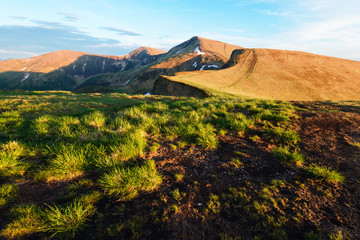 View of the stony hills glowing by evening sunlight. Dramatic spring scene. Landscape photography