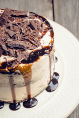 Fresh chocolate cake on the dark rustic background. Selective focus.