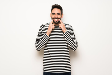 handsome man with striped shirt smiling with a happy and pleasant expression