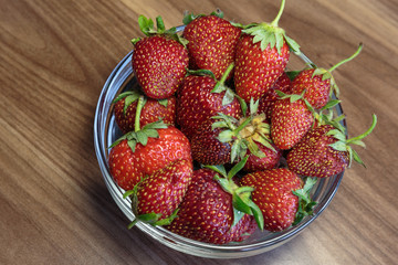 Fresh strawberry in the glass bowl closeup. Concept of a vegan breakfast.