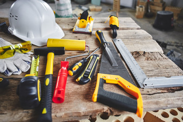 Home repairs. Construction tools, bricks and helmet