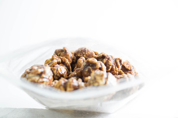 Chocolate covered popcorn in a clear plastic bag.