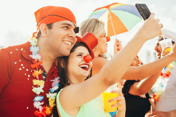 Brazilian Carnival. Couple in costume taking a self portrait