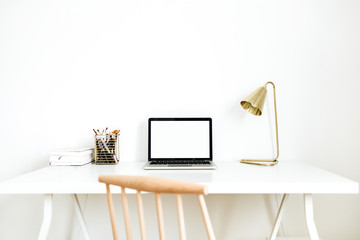 Bright home office desk workspace with mockup screen laptop. Nordic modern minimal interior design concept. Desktop table and wooden chair in white room.