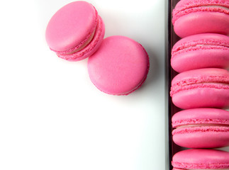 Pink macarons or macaroons in the black box. Background with Copy space or place for text.