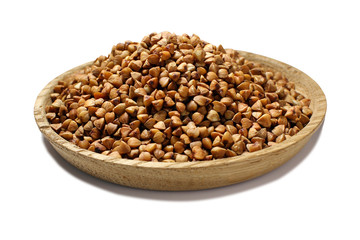 A full wooden plate of buckwheat groats, isolated on a white background. Buckwheat.