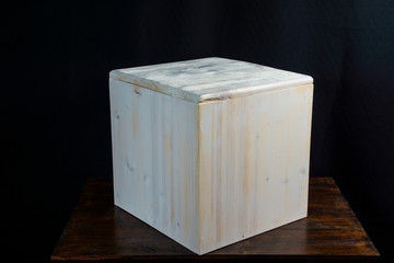 Handmade white wooden cube stool with carved abstraction