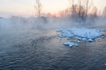A lake of mist above him is floating winter sunset.