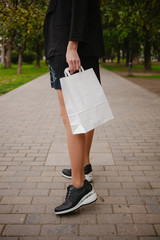 woman hold a paper shopping bag close up