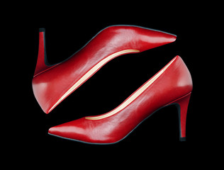 Elegant women's shoes made of red leather on a black background
