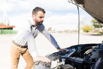 Handsome Man Standing Near Car With Open Hood