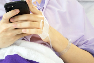 Patient hold smartphone in his hand. Never stop to using mobile phone. Social networking addiction.