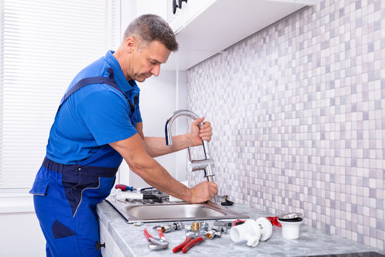 Worker Fixing Water Tap - Powered by Adobe