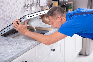 Obraz premium Repairman Installing Induction Stove