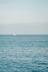 Fototapeta premium Sailboat in the Mediterranean, from La Barceloneta, in Barcelona, Spain