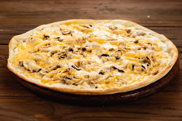 Appetizing pizza on a wooden background