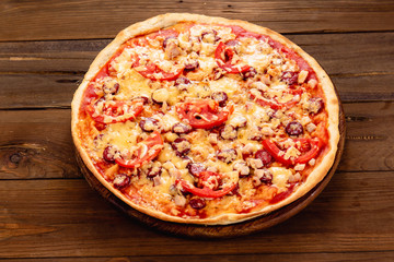 Appetizing pizza on a wooden background