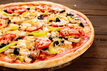Appetizing pizza on a wooden background