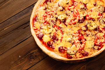 Appetizing pizza on a wooden background