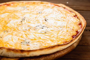 Appetizing pizza on a wooden background
