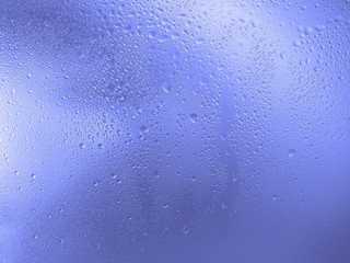 Drops of water on the glass, blue color. Image for background or wallpaper.