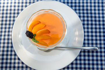 apricot dessert with jelly and milk cream, decorated with mint