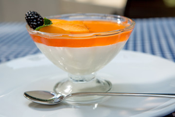 apricot dessert with jelly and milk cream, decorated with mint