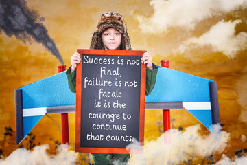 Boy holding chalkboard
