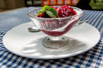 dessert of strawberry puree with mint on a served table