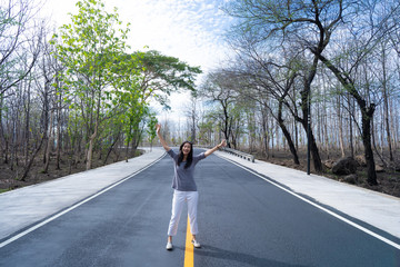 asian female standing in the middle of the road