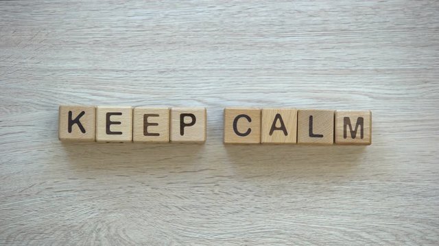 Keep calm, hands turning words on wooden cubes, positive thinking and motivation