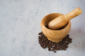 wooden mortar and pestle with coffee beans