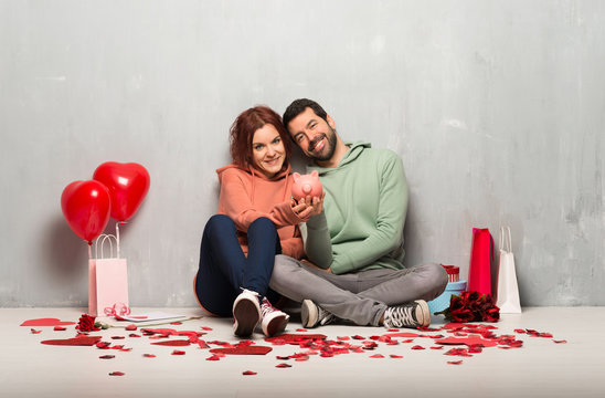 Couple in valentine day holding a piggybank - Powered by Adobe