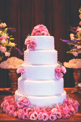 cakes decorated for social events, modern wedding cake with decorative flowers.