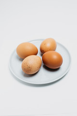  Brown chicken fresh tasty healthy egg on a plate top view. Eggs on a plate on a white background photographed close